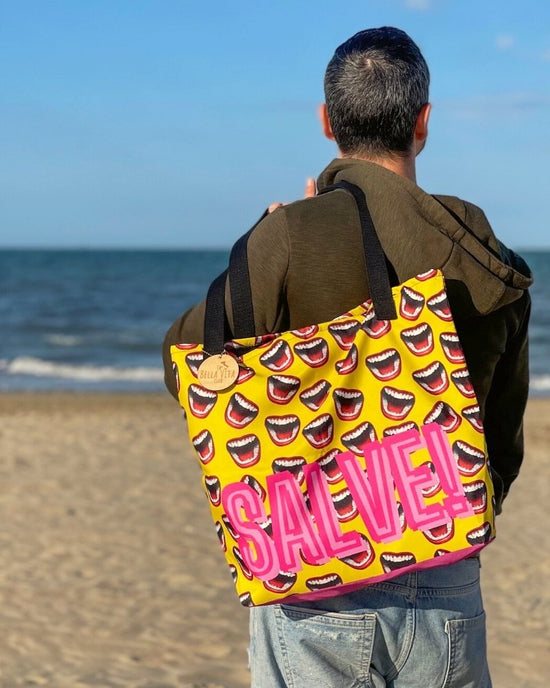 you can see the salve and ciao design for our statement bag collection. you see a male model posing at the beach in rimini. our collection is dedicated to italy. 