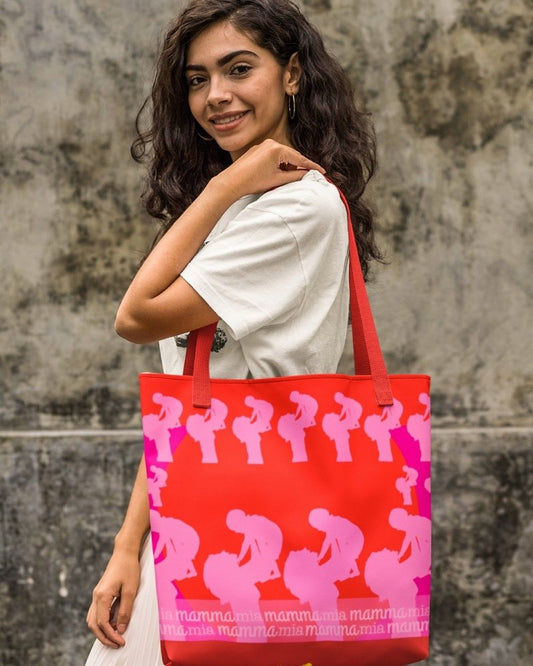 The main colours of the design are pink and red. On one side you see a woman holding up a little baby. on the other side you see several prints of this woman, plus the inscription "mamma mia". 